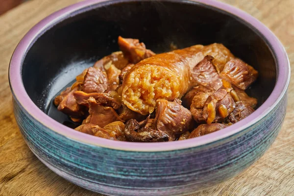 Meat navels cooked in a slow cooker with sausage in the intestine.