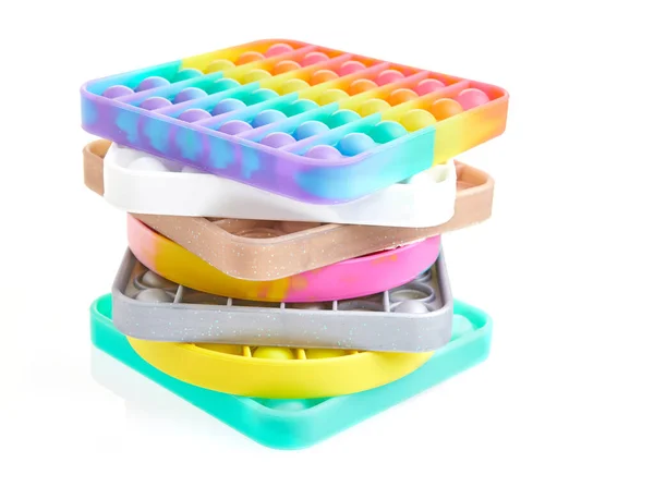 Juguetes coloridos del antiestrés sensorial de la burbuja del pop-push, apilados en la pila aislada en fondo blanco — Foto de Stock