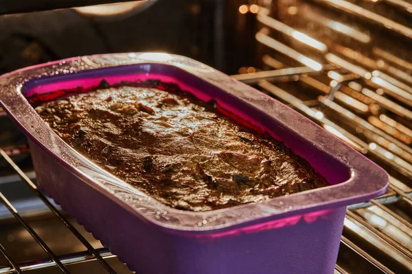 Bak de aubergine taart in siliconen vorm in elektrische oven — Stockfoto