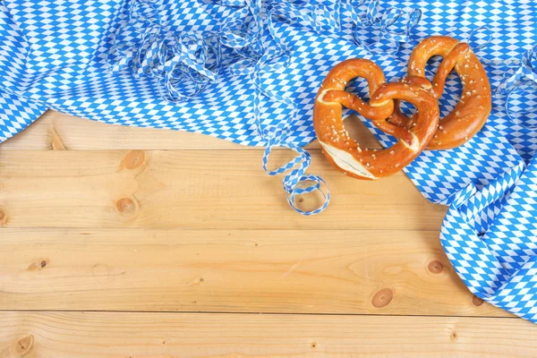 Salty pretzels on wooden board — Stock Photo, Image