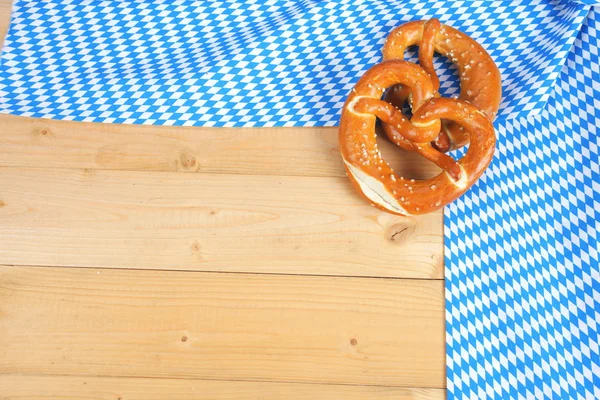 Salty pretzels on wooden board — Stock Photo, Image