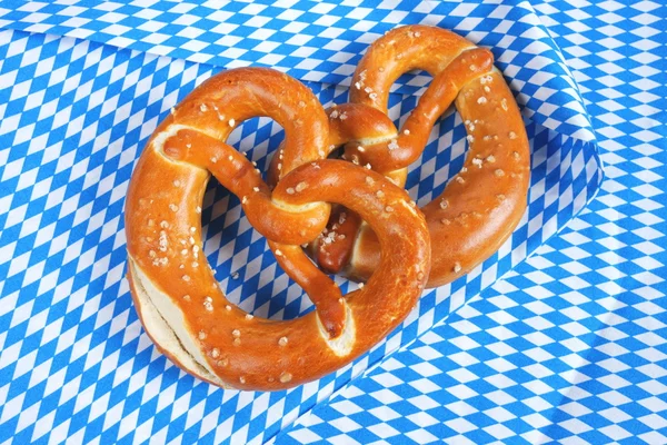 Salty pretzels on wooden board — Stock Photo, Image