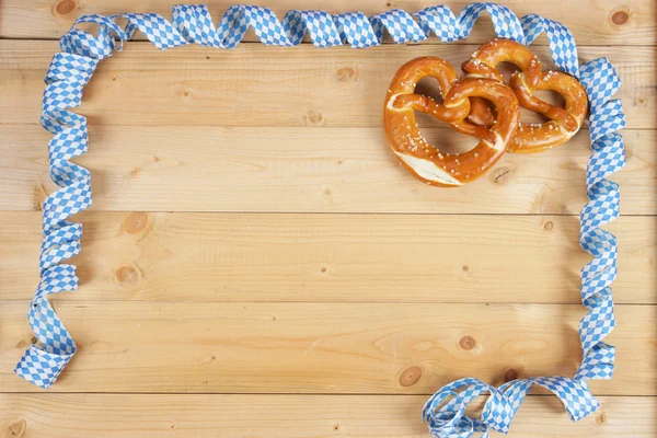 Salty pretzels on wooden board — Stock Photo, Image