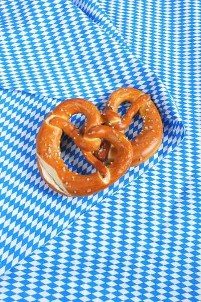 Salty pretzels on wooden board — Stock Photo, Image