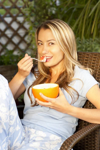 Woman eating muesli on the terrace — Stock Photo, Image