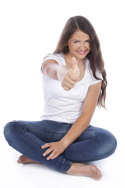 Teenage girl sitting with thumbs up — Stock Photo, Image