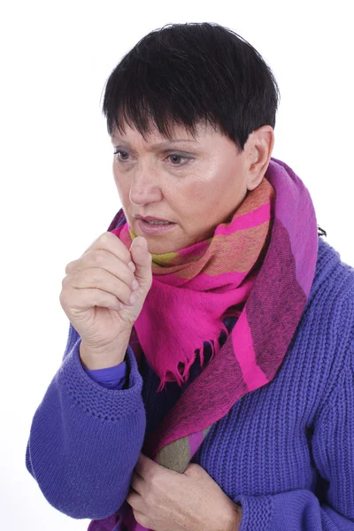 Elderly coughing woman with scarf and pullover — Zdjęcie stockowe