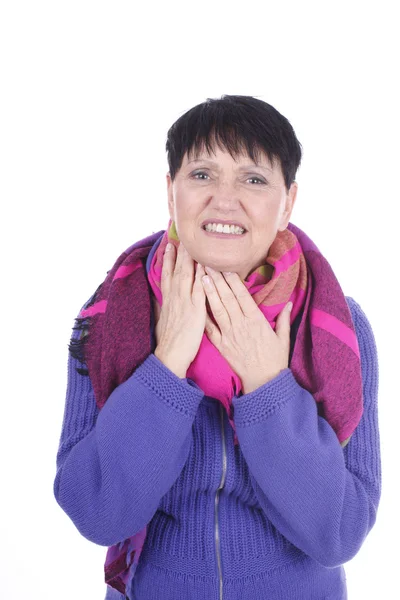 Elderly woman touches her throat — Stok fotoğraf