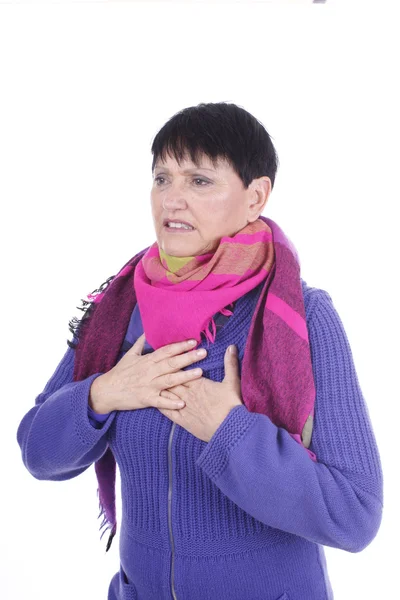 Elderly woman touches her chest — Stockfoto