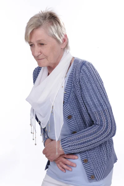 Äldre kvinna med ont i magen — Stockfoto