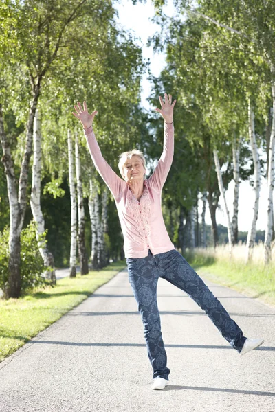 Happy senior woman active in nature — Stock Photo, Image