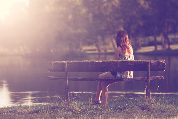 Girl sitting in a bench