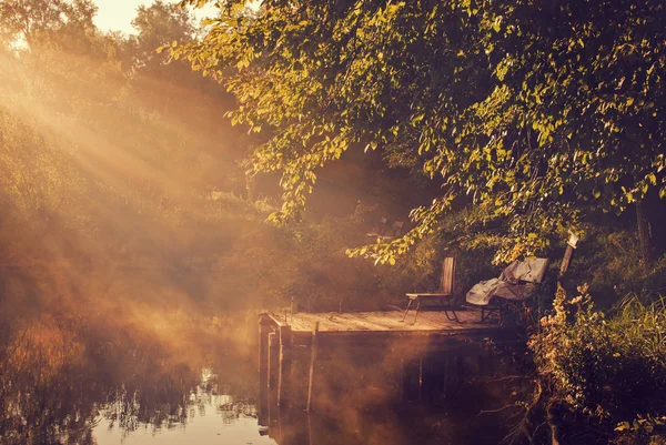 Old chair on pier — Stock Photo, Image