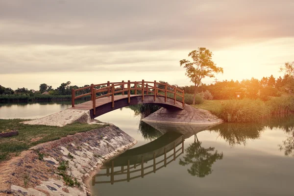 Bridge in the park at sunset — Stock Photo, Image
