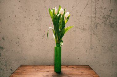 Yeşil şişe içinde beyaz laleler