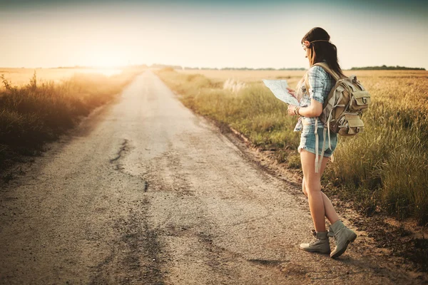 Traveler hippie girl looking on map — Stock Photo, Image