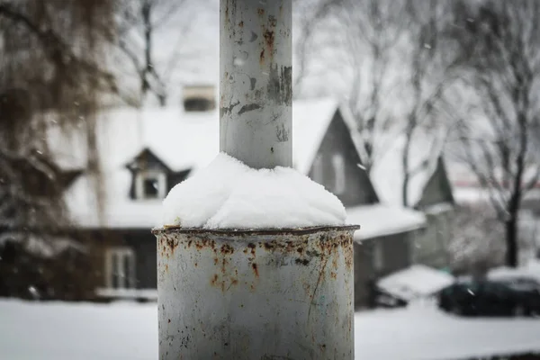 雪の背景に覆われた郡側の街灯柱に付着した雪のドリフト — ストック写真