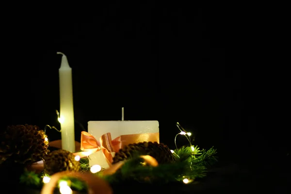 Decoraciones navideñas rosas con velas sobre fondo negro — Foto de Stock