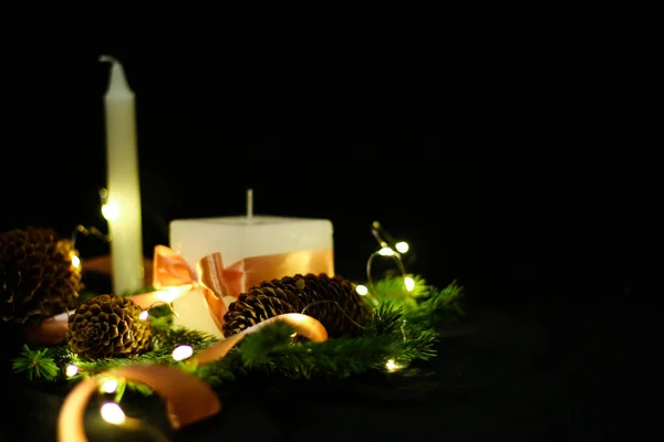 Pink Christmas decorations with candlels on a black background — Stock Photo, Image