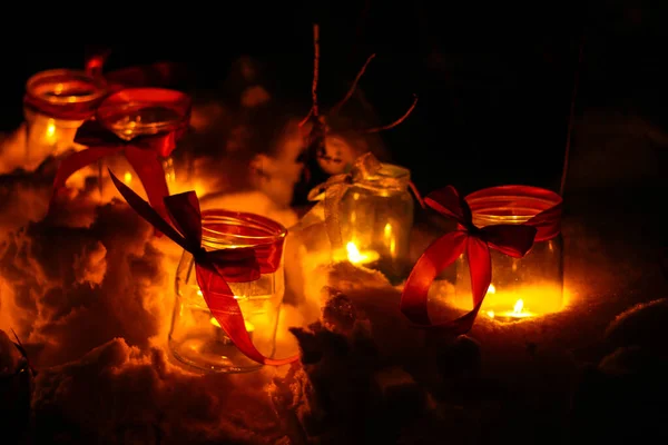 Small Candle Burns Jar Dark Background Bokeh Lights Red Ribbon — Stock Photo, Image