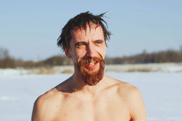 若いです スリムです ハンサムです 赤いひげと長い髪を持つスポーティ男 氷の水で泳ぐ後にダイビング 冬に氷の冷たい水に晴れた霜の日に ウクライナを背景に ショスタカ — ストック写真