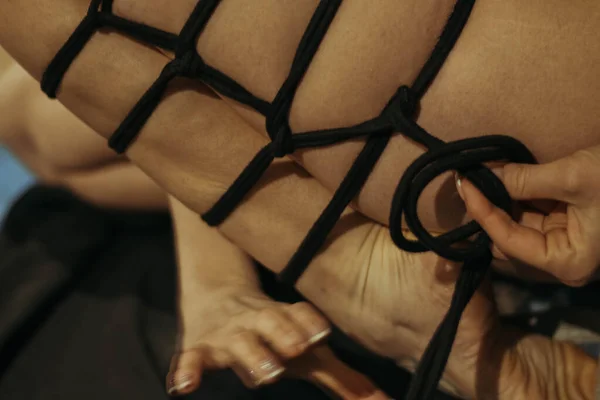 Submission slave woman legs bound in erotic fashion style rope shibari kinbaku Japanese bondage knot. Bdsm sadomasochism mistress master dominant fetish punishment flogging sadism masochism concept.