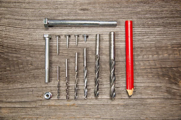 Timmerman tools. Schroeven, boren, moer, potlood, bovenaanzicht — Stockfoto