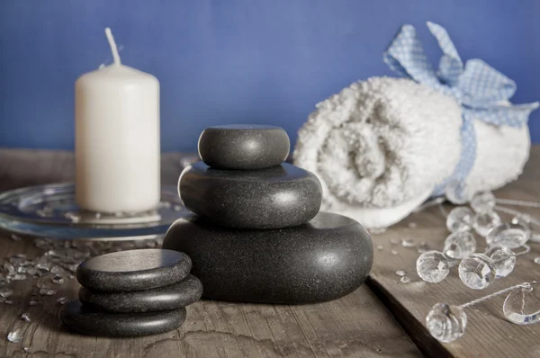 Blue white spa set. Massage stones, candle, towel. — Stock Photo, Image