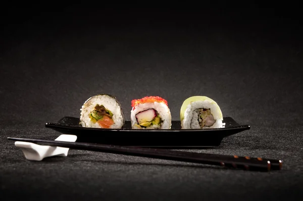 Luxurious sushi on black background - japanese cuisine — Stock Photo, Image