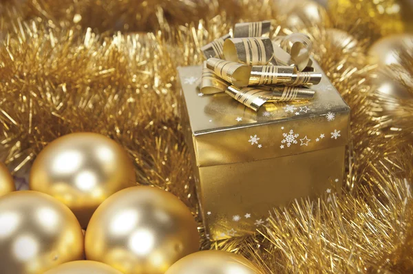 Golden christmas gift and baubles — Stock Photo, Image