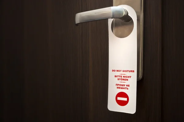 Do not disturb sign on closed door handle