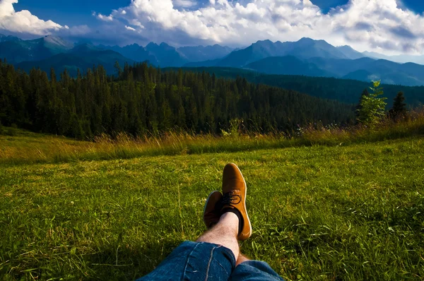 Man relaxing, enjoying mountain landscape on sunny day — Stockfoto