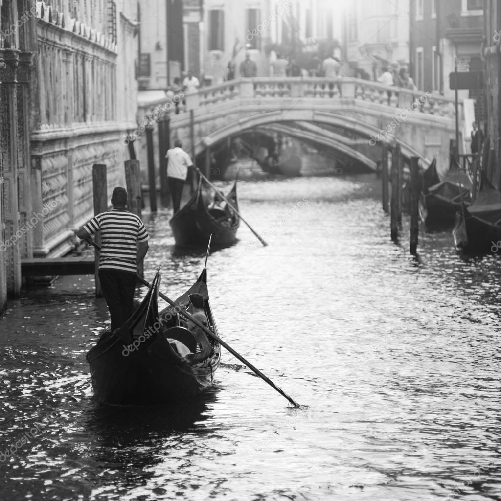 two gondolas with gondoliers in Venice, Italy