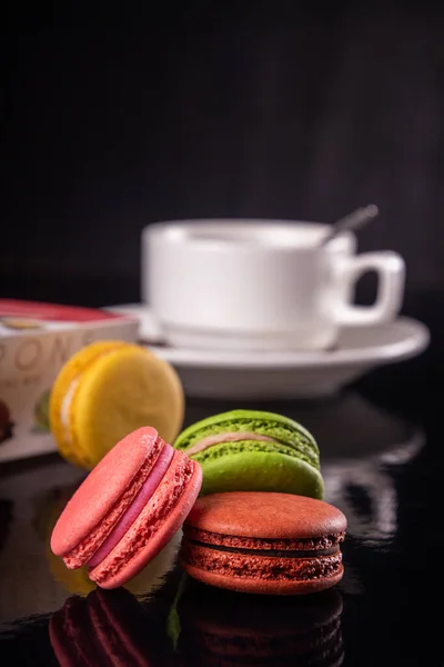 Macarons Coloridos Xícara Café Sobre Fundo Preto — Fotografia de Stock