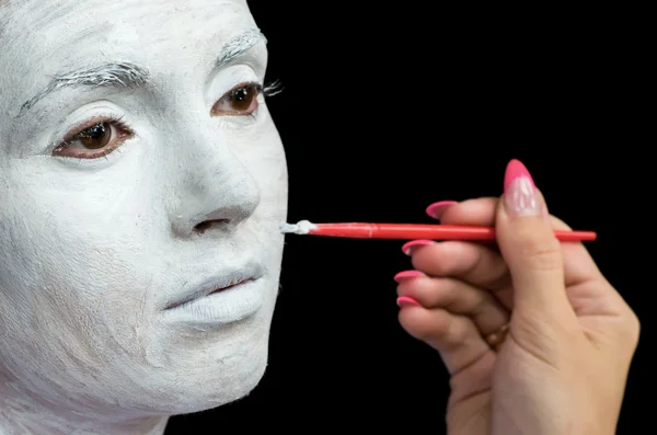 Applying makeup to beautiful young woman. Stock Photo