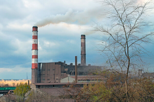 Ukraine, Dneprodzerzhinsk, Fall 2015. Factory pipe smoke polluting the atmosphere. Editorial illustration