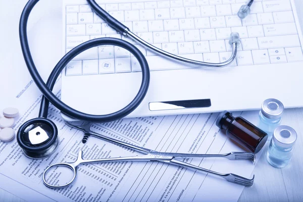 Medical devices on the table at the doctor with blue toned — Stock Photo, Image