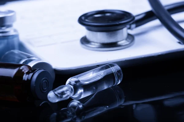 Medical devices on the table at the doctor with blue toned — Stock Photo, Image