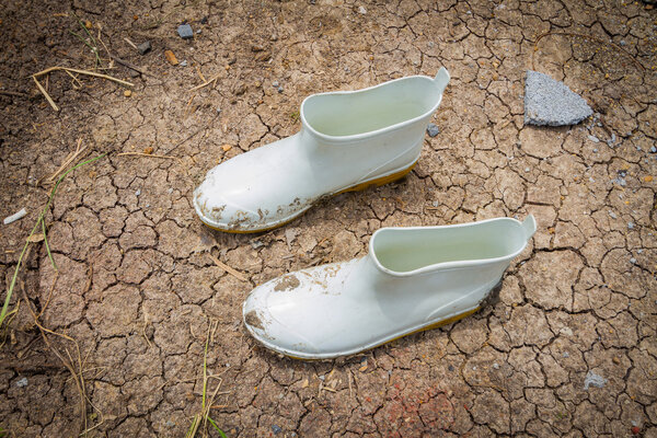 Dirty rubber boots in farm