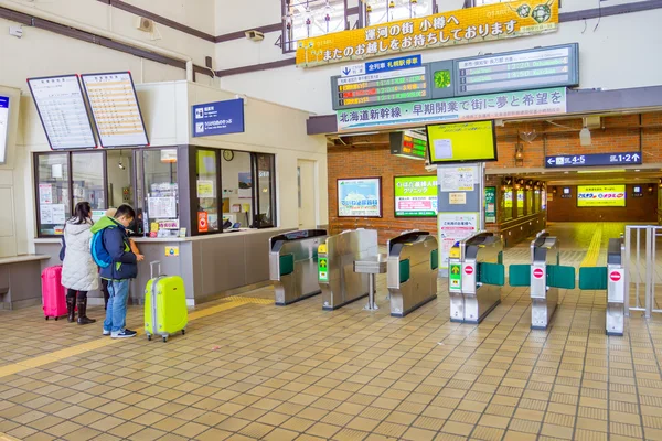 Passengers buying tickets from vending machines
