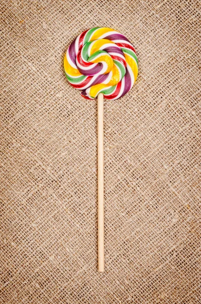 Lollipop op rustieke achtergrond — Stockfoto