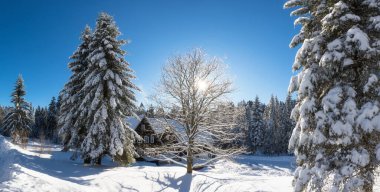 The beautiful Chalet Serlissky Mlyn located in the Eagle Mountains, near to the famous ski resort of Destne v Orlickych horach in the north of the Czech Republic during sunny day in winter season.