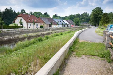 Modern flood protection wall in the style of the historic city wall. Permanent measures against floods. gate valves and walls. Flood gates protecting city against flooding from stream.
