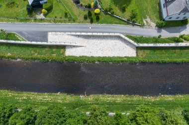 Modern flood protection wall in the style of the historic city wall. Permanent measures against floods. gate valves and walls. Flood gates protecting city against flooding from stream.