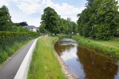 Modern flood protection wall in the style of the historic city wall. Permanent measures against floods. gate valves and walls. Flood gates protecting city against flooding from stream.
