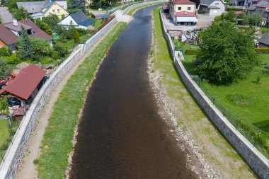 Modern flood protection wall in the style of the historic city wall. Permanent measures against floods. gate valves and walls. Flood gates protecting city against flooding from stream.