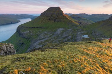 Faroe Adaları 'nın tepesinde. Güneşli bir günde yüksek dağ zirveleri manzarası. Okyanus manzaralı. Güzel panoramik manzara. Kuzey Avrupa. Seyahat kavramı