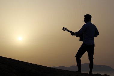 adam sahilde gitar çalmak