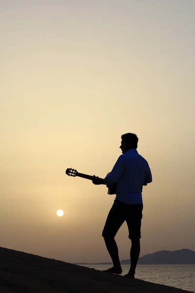 Hombre tocando la guitarra en la playa — Foto de Stock