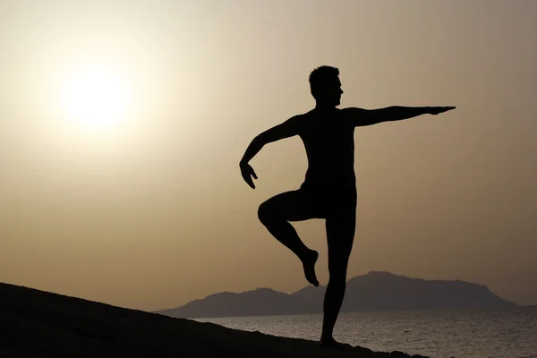 Silhouette di un uomo che fa yoga, tai chi — Foto Stock